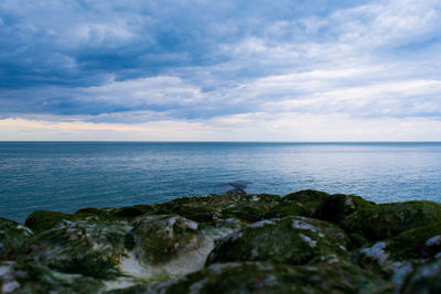 Scenic view of sea against cloudy sky