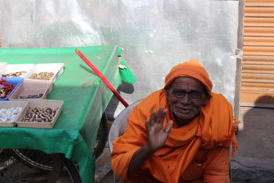 Portrait of senior man in traditional clothing sitting outdoors