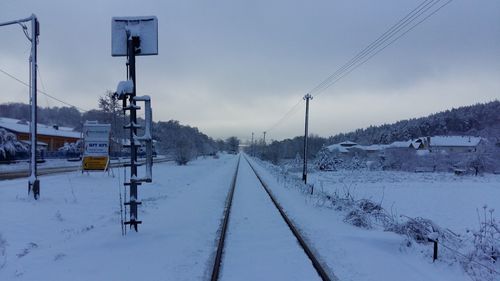 High angle view of snowcapped railroad track against sky during winter