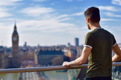 Rear view of man standing on city