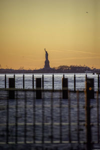 Statue of liberty against sky during sunrise
