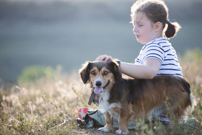 Woman with dog on field