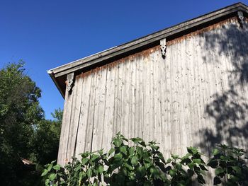 Low angle view of old building against clear blue sky