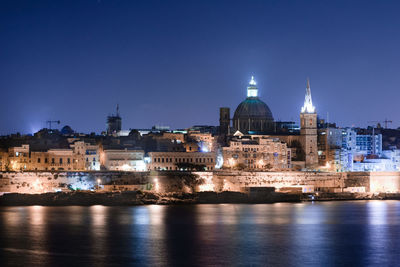 Illuminated buildings in city at night