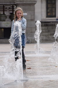 Full length of woman standing on street in city