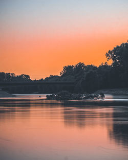 Scenic view of lake against romantic sky at sunset