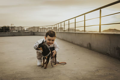 Cute boy with dog on terrace