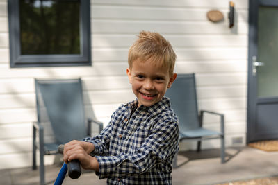 A boy standing in a wagon.