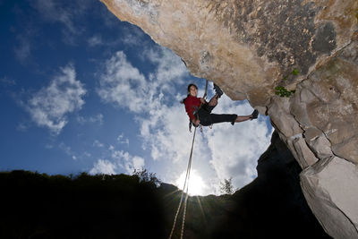 Woman rappelling from cliff in swanage / uk