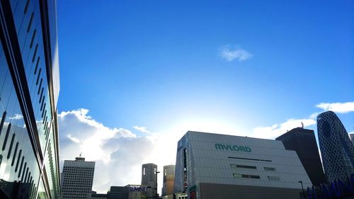 Low angle view of office building against blue sky