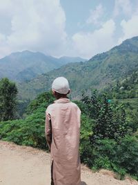 Rear view of man looking at mountains