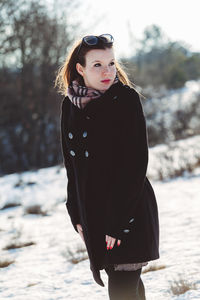 Portrait of beautiful woman standing on land