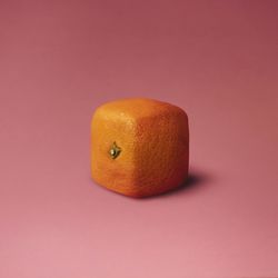 Close-up of square orange against pink background