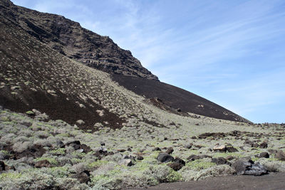 Low angle view of rocky mountain against sky