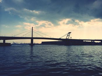 Bridge over river at sunset