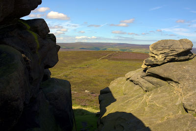 Rock formations on landscape against sky