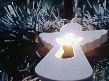 Close-up of illuminated lamp on table