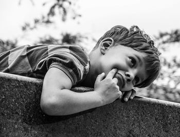 Portrait of boy lying outdoors