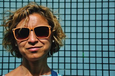 Close-up portrait of young woman wearing sunglasses