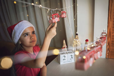 Portrait of cute girl playing with toys on table