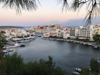 High angle view of buildings by sea against sky