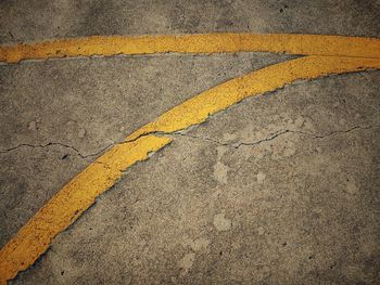 High angle view of yellow road sign on street