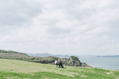 People on land against sky