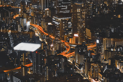 High angle view of illuminated buildings in city at night