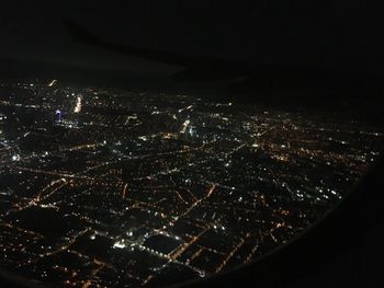 Aerial view of city lit up at night