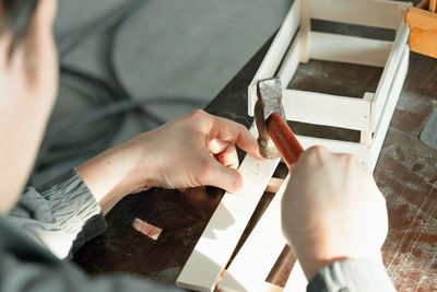 Cropped image of carpenter using hammer