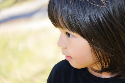 Close-up portrait of serious young woman looking away