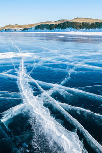 Scenic view of frozen sea against blue sky