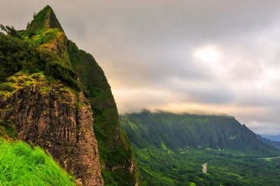 Scenic view of mountains against cloudy sky