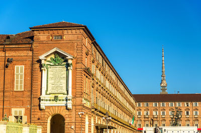 Low angle view of historical building against blue sky