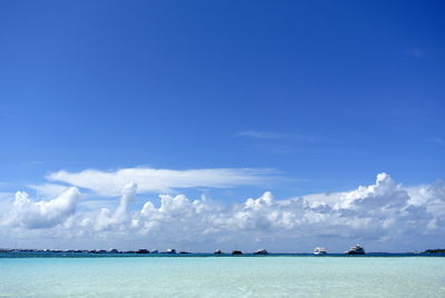 Scenic view of sea against blue sky