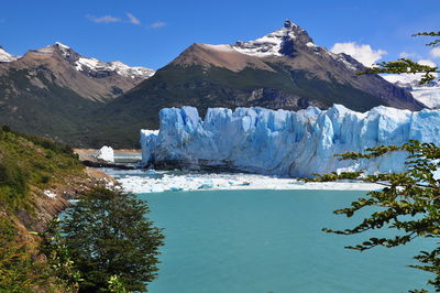Scenic view of snow covered mountains against sky