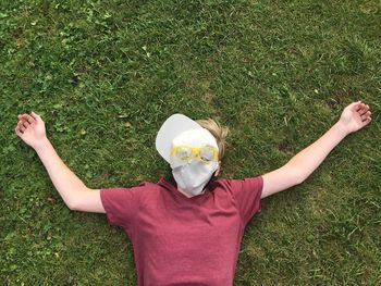 Directly above shot of man lying on grassy field