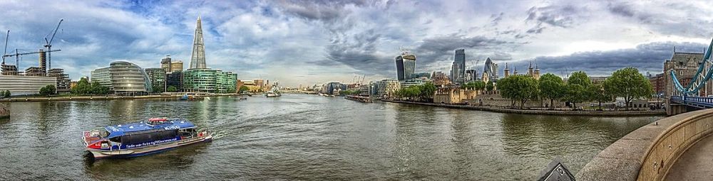 Boats in river with buildings in background