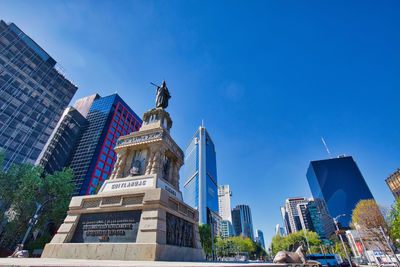 Low angle view of buildings against blue sky