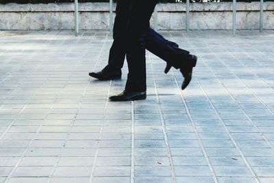 Low section of woman walking in city