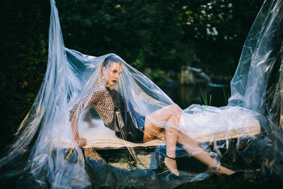 Woman covered in plastic on field