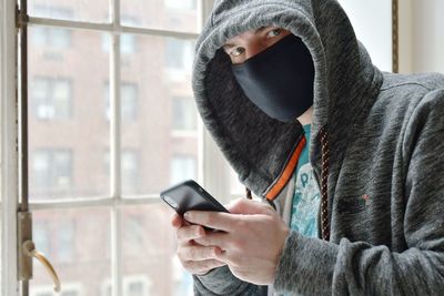 Man using mobile phone in winter