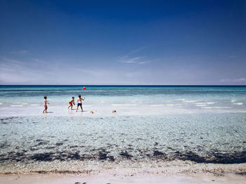 People on beach against sky