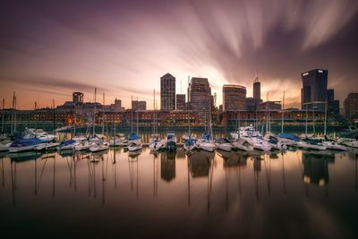 Harbor with buildings in background at sunset