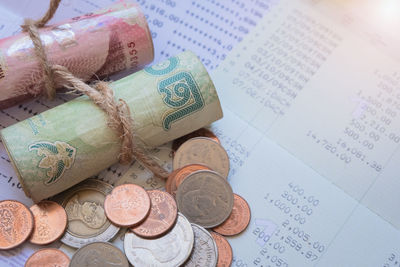 High angle view of coins on paper