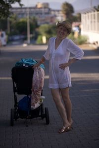 Side view of young woman standing on street