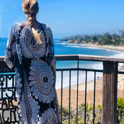 Rear view of woman looking at sea against sky