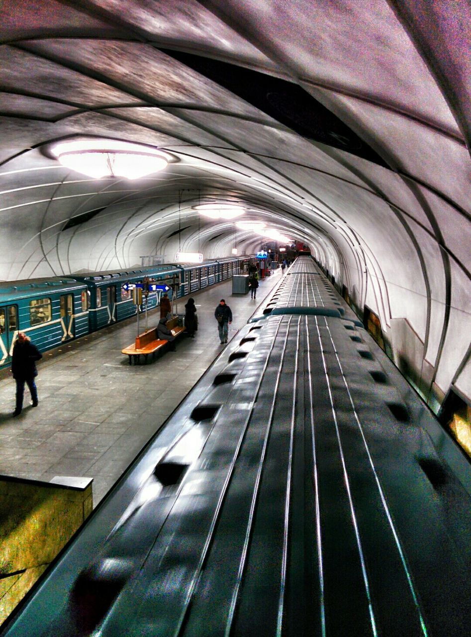 indoors, the way forward, diminishing perspective, men, walking, vanishing point, ceiling, person, transportation, lifestyles, large group of people, architecture, incidental people, rear view, built structure, tunnel, leisure activity, full length, travel