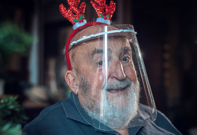 Portrait of senior man wearing face shield