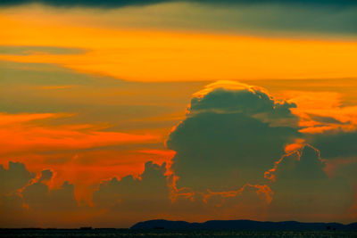 Scenic view of dramatic sky over sea during sunset